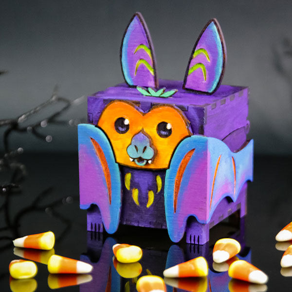 Halloween - image features: Laser cut bat treat box surrounded by candy corn