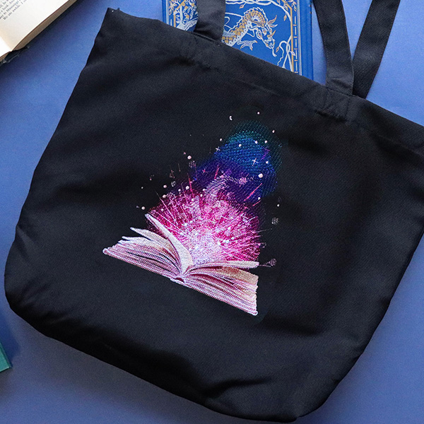 Stitched for Adventure - image features: glowing book on tote - click here to shop