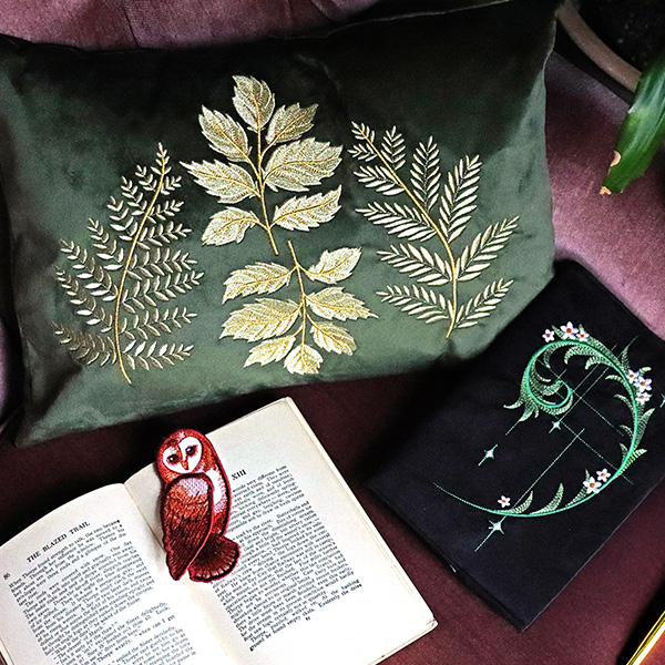 Wildwood collection - image features: botanicals on pillow and journal, owl bookmark - click here to shop